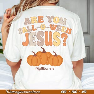 May include: White t-shirt with the text "Are you Fall-O-Ween Jesus?" in orange, yellow, and brown lettering. Three orange pumpkins are below the text with the words "Matthew 9:19" underneath.