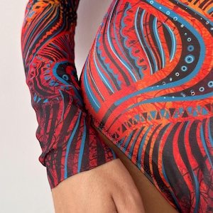 May include: A vibrant, patterned bodysuit featuring a striking design in red, black, and blue. The long-sleeved garment showcases an intricate, abstract pattern with a mesh-like texture, creating a bold and artistic look. The bodysuit's design is eye-catching and suitable for various occasions.