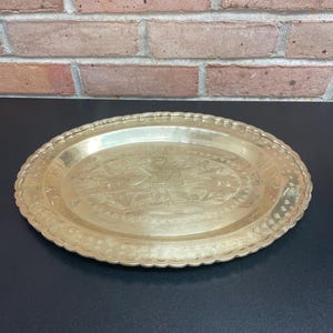 Vintage Brass Tray with Wall Hanging Hook Mounted on Back Bird and Flowers Engraved and a Decorative Trim all around 14 1/4 Inches Wide
