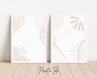 May include: Two framed prints with abstract designs in shades of pink and beige. The designs feature geometric shapes, dots, and lines.