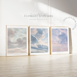 Puede incluir: Tres impresiones de arte de pared vintage imprimibles que presentan pinturas de nubes en un esquema de color azul pálido y rosa. Las impresiones están enmarcadas en un marco de madera simple y claro. El texto en las impresiones dice "Cloud Study from Sunset", "Study of a Cumulus Nimbus" y "Study of a Cumulus Cloud".