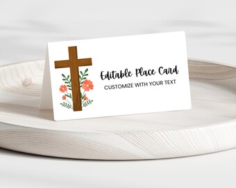 May include: Editable place card with a brown wooden cross and pink flowers. The text reads "Editable Place Card Customize with your text".