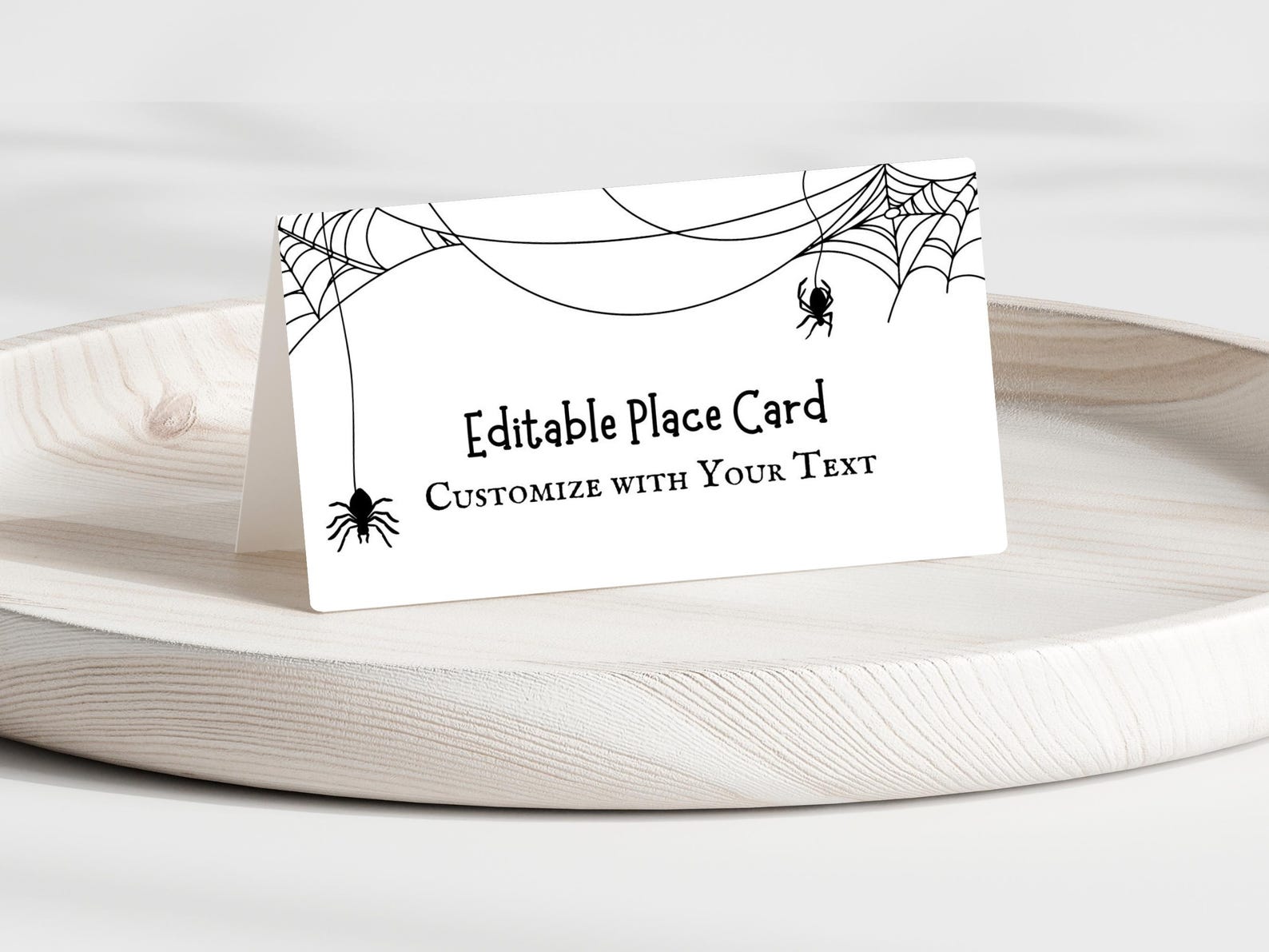 A Loose Web Across the Top Edge Editable white place card with thin black webs and a central name area.