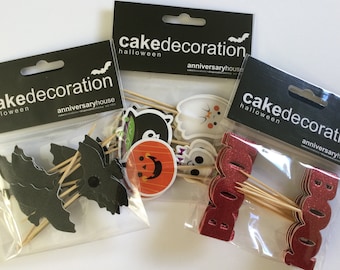 12 Double Sided Halloween Cupcake Picks. Glitter Black Bat Cake Decorations. Red BOO! Cupcake Toppers. Fun Halloween Icon Toppers.