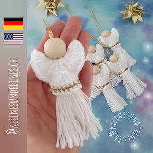 May include: A set of five white crocheted angel ornaments with gold trim and wooden beads. Each angel has a long white tassel.