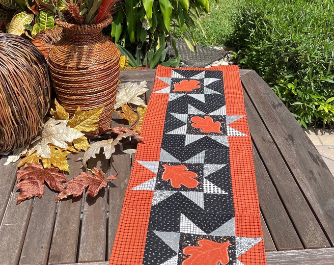 Autumn themed, orange, black with fall leaves table runner