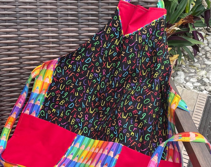 Red, black with primary colored alphabet, three pocket apron