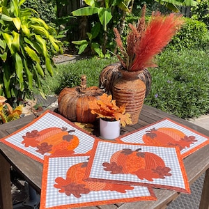 Appliqued various orange fabric pumpkins with autumn leaves on gray checkered fabric