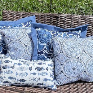Decorative outdoor, handmade, slipcover style pillow covers in a variety of beautiful blue fabrics
