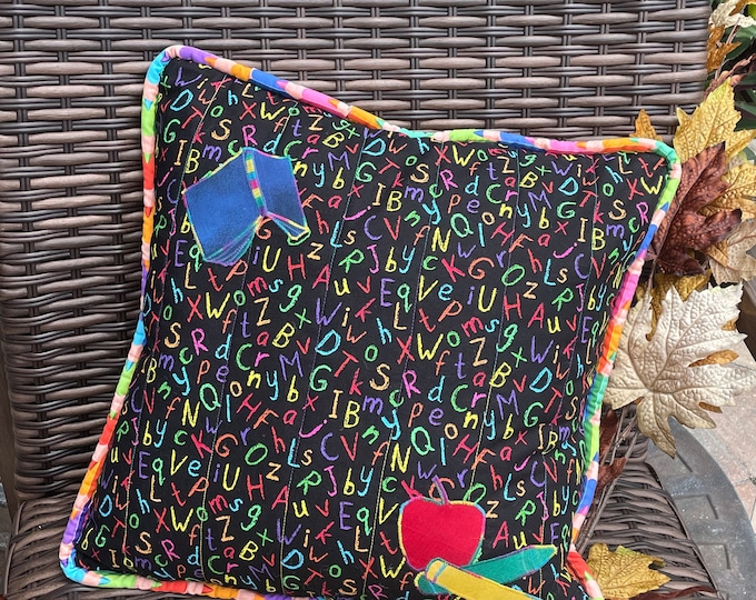 Black with ABC's fabric pillow cover with decorative buttons and snap closure
