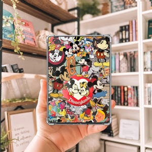 May include: A clear phone case featuring a collage of Disney characters, including Mickey and Minnie Mouse, Donald Duck, and Goofy. The design incorporates various colors and the word "Disneyland".