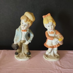 Vintage hecho a mano pintado a mano par de figuras de porcelana para niños y niñas con bolsa de medicina niña con canasta de flores