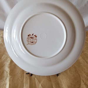 May include: White ceramic plate with a brown rim and a brown logo that reads "Made in Belgium Boch Fr&egrave;res" in a circle.