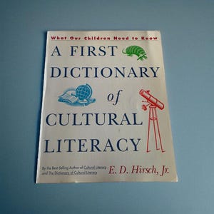 May include: A First Dictionary of Cultural Literacy book. The cover features the title in blue text, with illustrations of a globe, open book, and a telescope. The author's name is E. D. Hirsch, Jr.