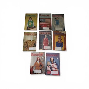 May include: A collection of eight vintage Workbasket magazines featuring various cover illustrations, including people wearing knitted garments, a large American flag, and a textured blanket, all arranged in a grid against a plain white background.