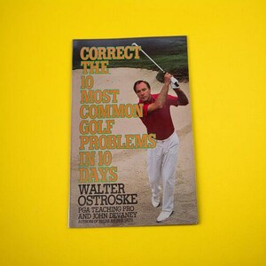 May include: A book cover with the title "Correct the 10 Most Common Golf Problems in 10 Days" featuring a man in a red shirt and white trousers swinging a golf club. The author's name is Walter Ostroske.