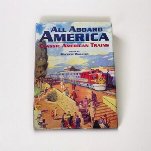 May include: A vintage book titled "All Aboard America" with the subtitle "Classic American Trains." The cover features a colorful illustration of a red and silver train, people, and a train station. The book is edited by Melville Wheaton.