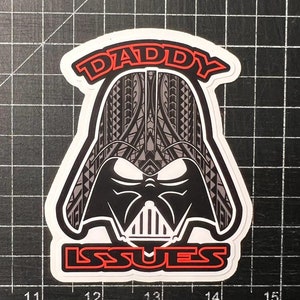 May include: A white sticker with a black and gray illustration of Darth Vader's head with a tribal pattern. The text "DADDY ISSUES" is in red around the image.