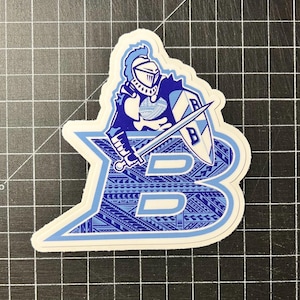 May include: A blue and white sticker featuring a knight holding a sword and shield with the letter "B" on it. The letter "B" is surrounded by a blue and white patterned design.