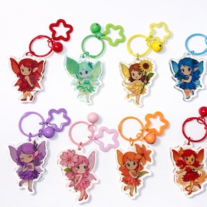 May include: A collection of colorful fairy keychains. Each keychain features a different fairy design with vibrant wings and outfits. The keychains have star-shaped accents and come in various colors, including red, green, yellow, and blue.