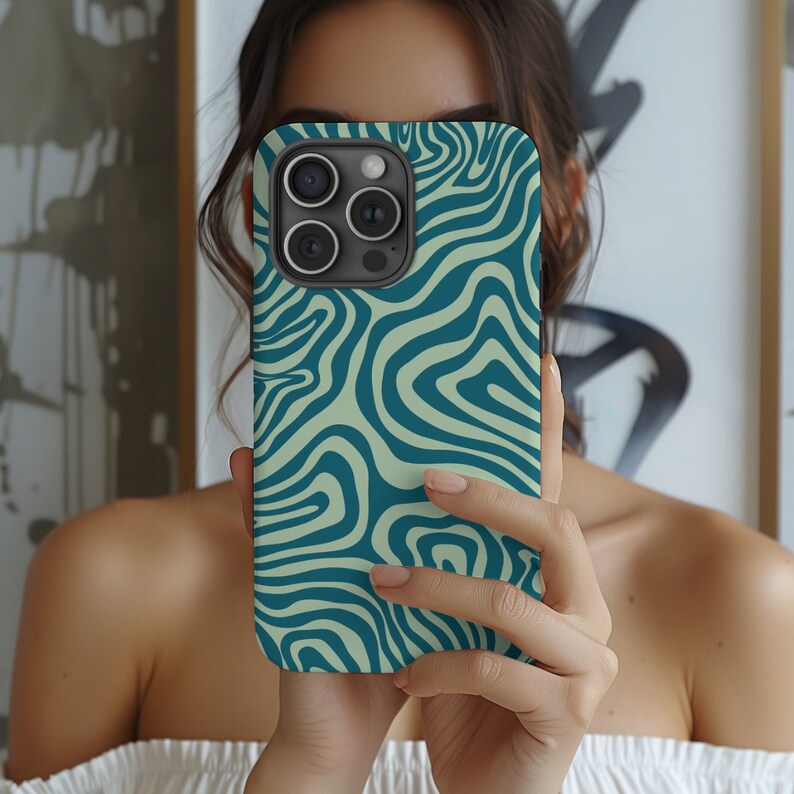 May include: A teal and cream swirl pattern phone case for an iPhone.