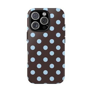May include: A brown phone case with a pattern of light blue polka dots. The case has a glossy finish and a black camera module. The design is repeated across the back of the case.