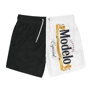 May include: Black and white swimming trunks with a Modelo Especial beer logo on the white side.