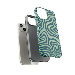 May include: A green and blue swirl patterned phone case for an iPhone. The case is shown with a silver iPhone.