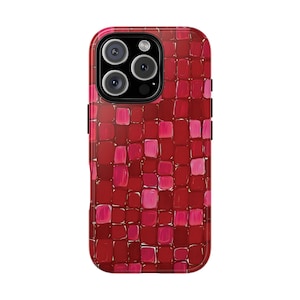 May include: A red and pink mosaic pattern phone case. The case has a glossy finish and a square pattern design. The camera lenses are visible at the top of the case.