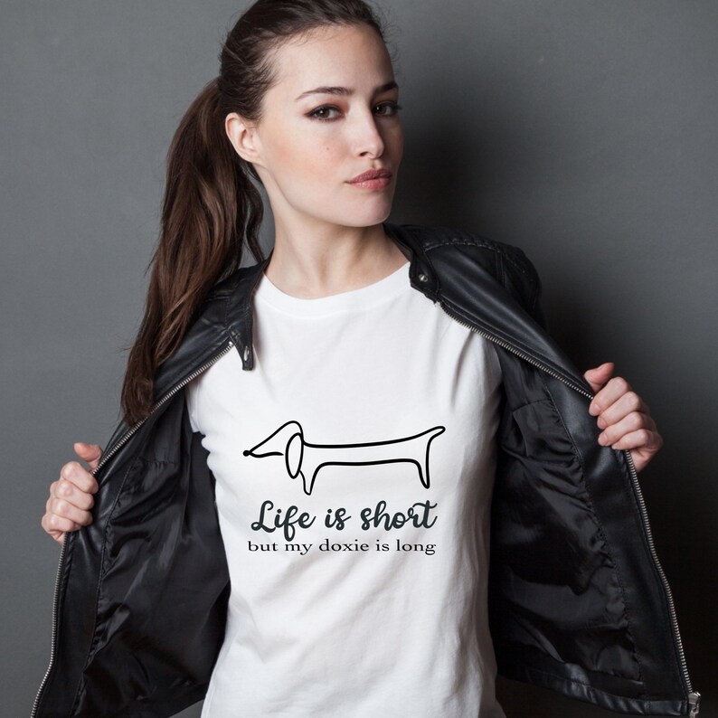 May include: White t-shirt with a black line drawing of a dachshund and the text "Life is short but my doxie is long".