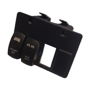 May include: Black switch panel with three labeled switches and a rectangular opening. The switches are labeled "LED LIGHT BAR" and "REAR LIGHTS". The panel has mounting tabs and a hole for installation.