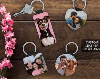 May include: Four custom leather keychains with different images. One keychain features a couple, another a dog, and two others feature families. The keychains are all made of brown leather and have a silver key ring.