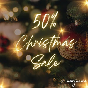 May include: A dark red Christmas ornament with a gold tree pattern hangs on a pine branch. The text 50% Christmas Sale is written in white script over the ornament, with the word merrymania in the bottom right corner against a bokeh background.