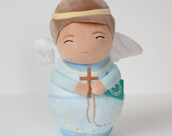 May include: A plush angel doll with brown hair, a halo, and wings. The angel is wearing a blue dress with a cross and a rosary. The doll is smiling and has its hands clasped in prayer.