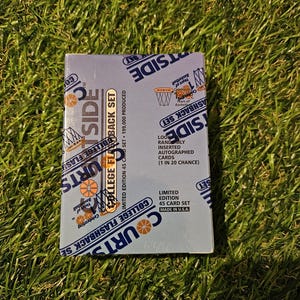 May include: A blue and white box for a set of 45 basketball trading cards. The box features a basketball hoop with a net and the text "Courtside College Flashback Set". The box also includes the text "Limited Edition 45 Card Set" and "Made in USA".
