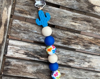 Blue cactus pacifier clip