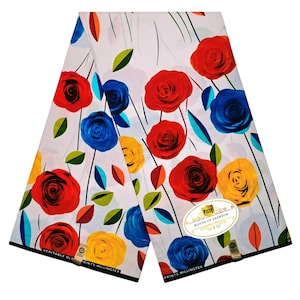 May include: A white fabric featuring a vibrant floral pattern of red, blue, and yellow roses with green and orange leaves. Thin black lines extend from the flowers. A label reads Pizzy House of Fashion, and the text Veritable Hollandais Prints Willingtex is visible.