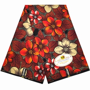 May include: A folded piece of fabric featuring a vibrant floral pattern with red, orange, and cream-colored flowers against a dark brown and black background. The textile includes a white oval label with the text Pizzy House of Fashion.