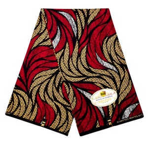 May include: A folded piece of fabric featuring a bold pattern of red, black, and tan wavy lines with dotted textures. An oval white label with gold trim displays the text Pizzy House of Fashion, and the fabric edge reads Guaranteed Printed By.
