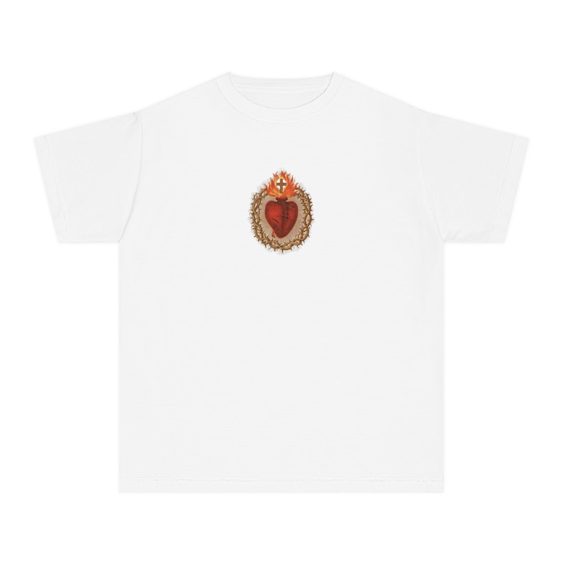 May include: White t-shirt featuring a graphic of a red heart with a crown of thorns and flames on the front.