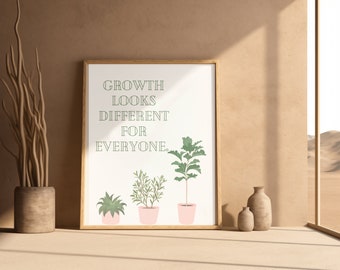May include: A framed print with the text "GROWTH LOOKS DIFFERENT FOR EVERYONE."  The print features three potted plants with green leaves against a white background.