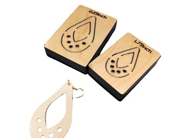 May include: Two wooden earring templates, one measuring 2.25 inches and the other 1.75 inches, with a cut-out teardrop shape and multiple holes. A finished leather earring in the same teardrop shape with holes is also shown.