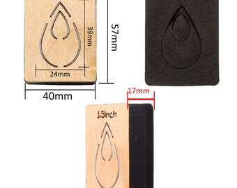 May include: A 1.5 inch wooden die-cutting template in the shape of a teardrop with a smaller teardrop inside. The template is 40 mm wide and 39 mm tall. The template is shown next to a black foam die-cutting pad.