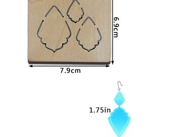 May include: A wooden die-cutting template for making earrings. The template features three different earring designs, each measuring 1.75 inches. The template is 7.9 cm wide and 6.9 cm tall.