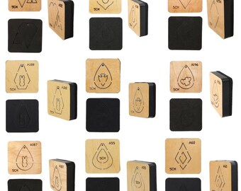 May include: A set of 10 wooden earring dies for crafting. The dies are 5 cm square and feature various shapes, including a diamond, a circle, a teardrop, a bunny, and a cloud. The dies are shown on a black foam surface.