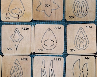May include: Nine different earring templates made of wood with a 5 cm diameter. The templates are labeled with the numbers A177, A198, A212, A220, A192, A143, A252, A235, and A64.