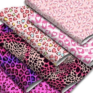 May include: A stack of pink and black patterned fabric with leopard print and hearts. The fabric is ideal for crafting, quilting, and sewing projects.