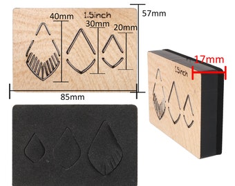 May include: A set of three leather earring punch dies with a 1.5 inch, 30 mm, and 20 mm size. The dies are made of wood and have a black foam backing. The dies are used to create earrings from leather.