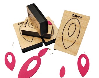 May include: A set of four wooden earring templates with different sizes, including 1.75 inch and 2.5 inch. The templates are used to cut out leather earrings. There are also four pink leather earrings cut out using the templates.