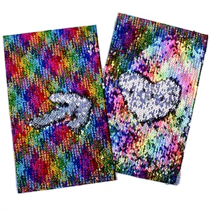 May include: Two notebooks covered in rainbow-coloured sequins. One has a silver dinosaur design, the other a silver heart. The sequins are reversible, creating a shimmering effect when flipped. Each notebook is approximately 20 cm in length.